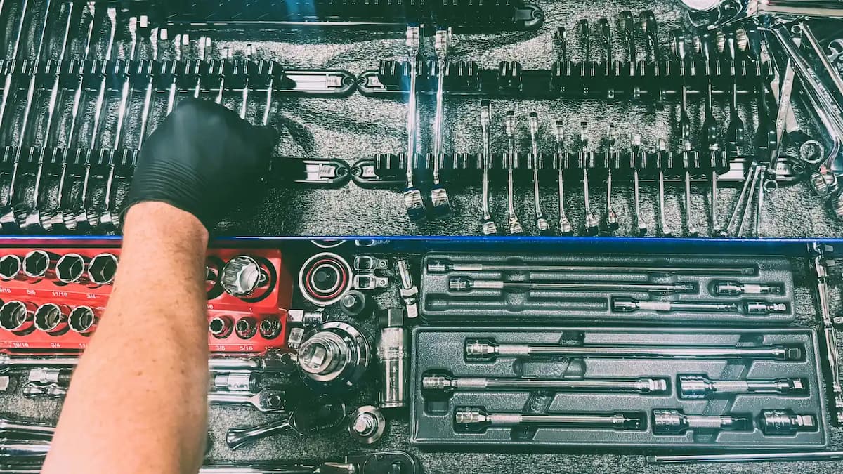 Aircraft mechanic reaching into tool box 