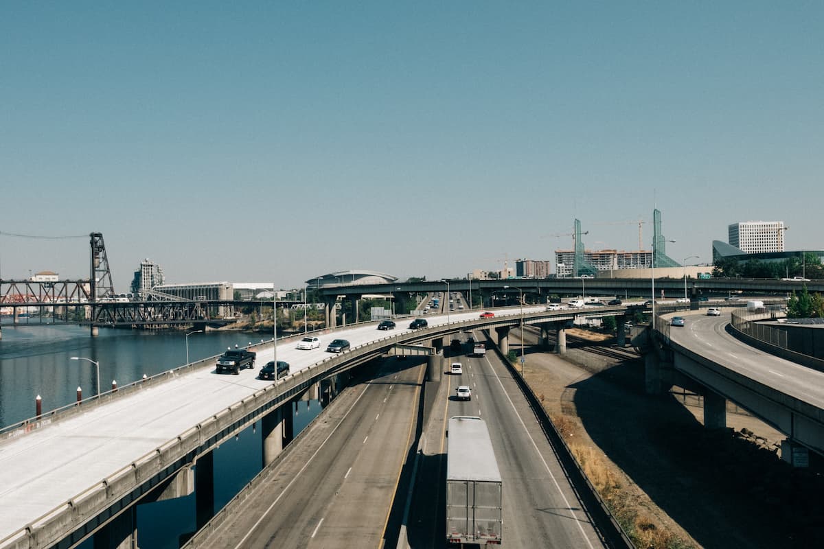 Highway traffic in downtown Portland with a view of the Willamette River, the Moda Center, and the Convention Center. 