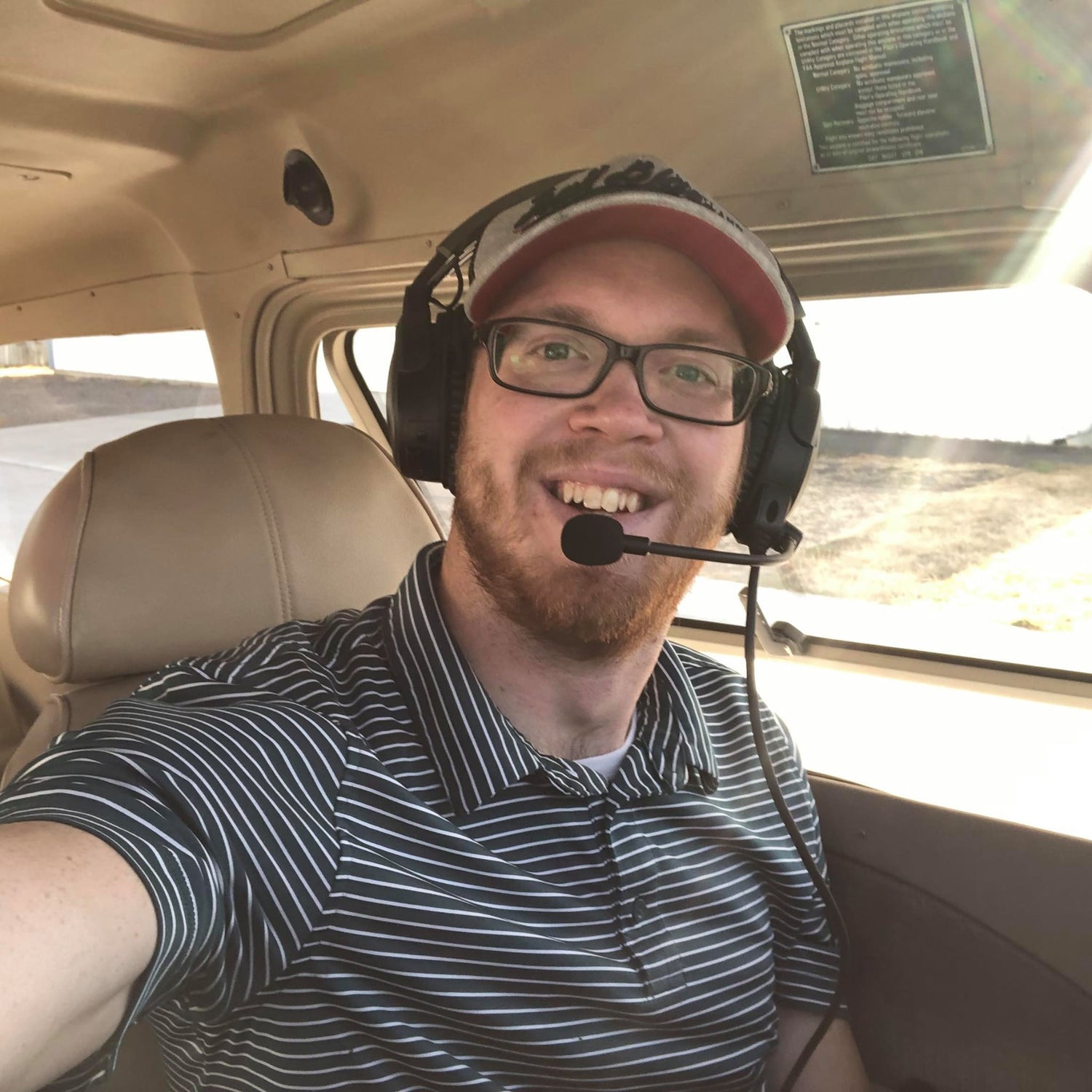 Pilot Mechanic in an airplane with headset on and ready for takeoff at the Aurora State Airport (KUAO).