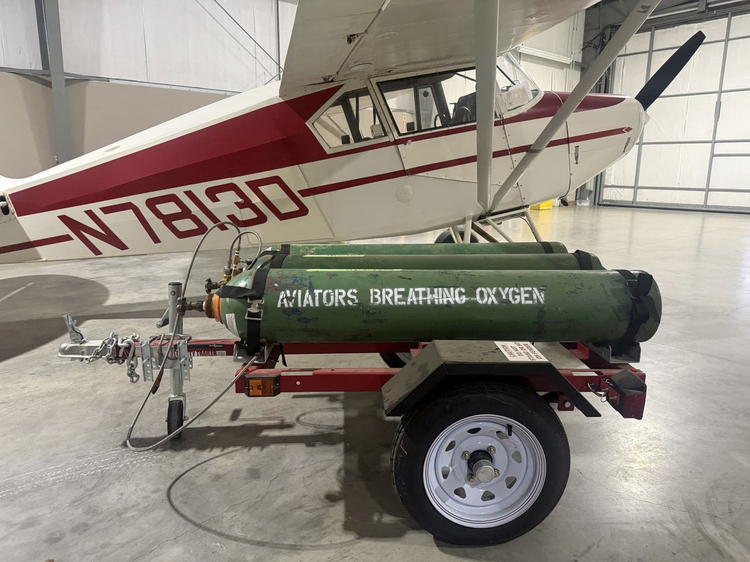 Oxygen tank on a trailer with 'Aviators Breathing Oxygen' branding against a plain background.