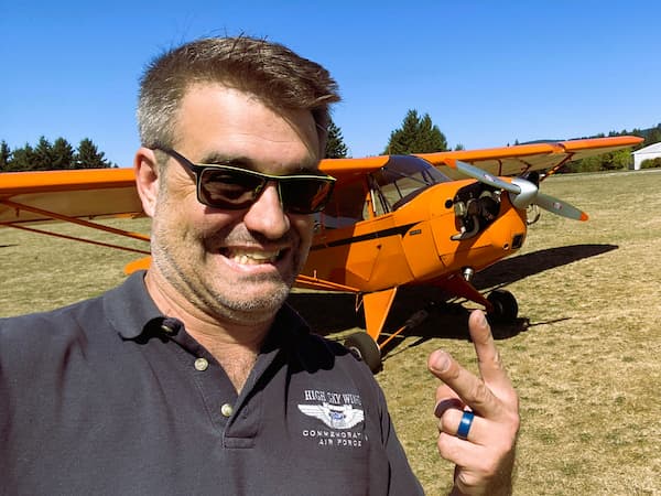 Commercial pilot with a tailwheel aircraft on a grass runway in the Willamette valley